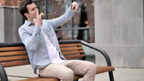 Outdoor-Young-Man-Taking-Selfie-on-Phone