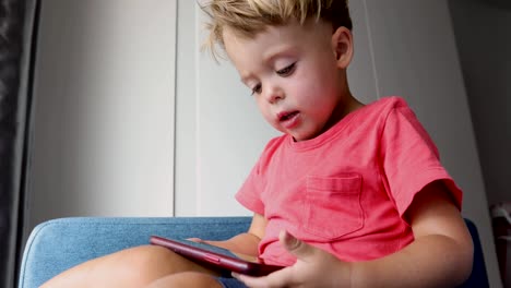 Content-kid-playing-smartphone-on-sofa