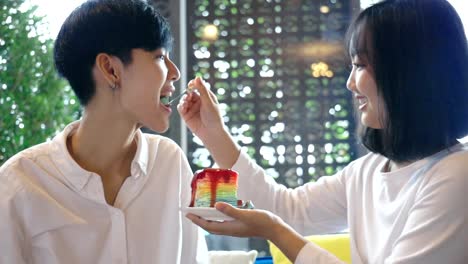 Young-Asian-Lesbian-Couple-Feeding-Sweet-Rainbow-Cake,-LGBT-Love-Moment-Slow-motion