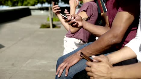 Side-view-of-people-using-digital-devices-on-street