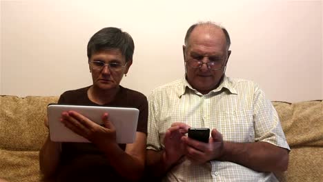 Attractive-adult-woman-and-adult-man-work-on-tablet-pc-and-smartphone.