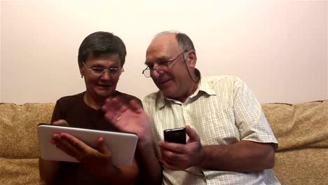 Attractive-adult-woman-and-adult-man-make-a-video-call-with-their-family-on-a-tablet-pc.