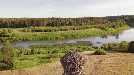 Aerial-view-of-the-Russian-forest,-river-and-steppe-overlooking-an-abandoned-Church-and-architectural-objects