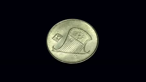 Israeli-coin-1/2-new-sheqel-rotates-on-a-black-background.-Macro.-Closeup