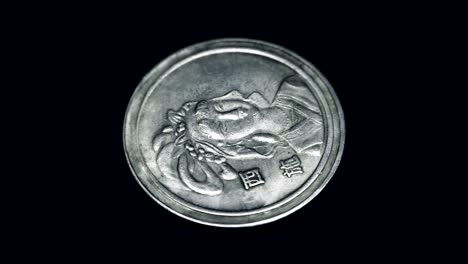 China-old-coin-(yuan)-rotates-on-a-black-background.-Macro.-Closeup