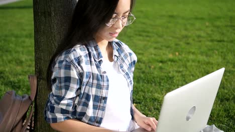 Adult-business-woman-entrepreneur-talking-on-phone-using-smartphone-and-looking-in-digital-computer-social-network