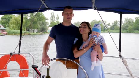 mom,-daddy-and-young-child-during-summer-holidays-on-river,-spouse-and-wife-with-small-kid-on-yacht,-family-travel