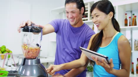 Healthy-Ethnic-couple-using-tablet-recipe-homemade-smoothie