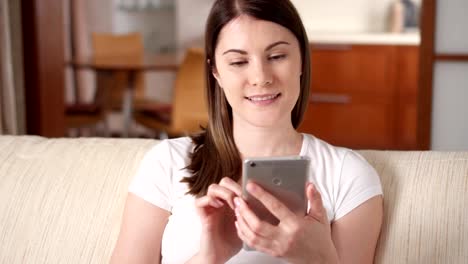 Woman-at-home-using-mobile.-Young-female-professional-having-conversation-on-smartphone,-browsing