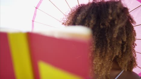 Plus-size-African-American-female-reading-by-ocean