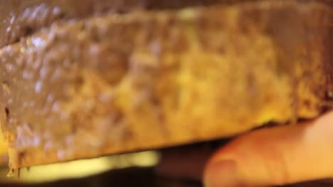 pastry-chef--hands-glazed-Easter-sweet-bread-cakes-with-chocolate,-closeup-on-the-worktop-in-confectionery