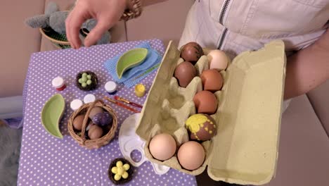 Woman-sorting-eggs-near-table