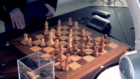 Close-up-view-on-robotized-arm-playing-chess.