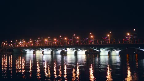 Chernavsky-Bridge-with-illumination-at-night-and-reflection-of-lights-in-water,-Voronezh