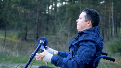 Disabled-man-is-moving-his-training-wheelchair-with-effort