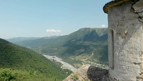 Departure-on-a-drone-from-the-ancient-dilapidated-Christian-church-standing-high-on-the-mountain.-Aerial-View.-North-Caucasus.-Russia