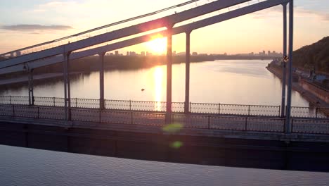 Aerial-shooting-pedestrian-bridge-of-Kiev-on-sunrise.-Summer-morning-in-Kiev-Dniepeer-river.-Ukraine.-European-city