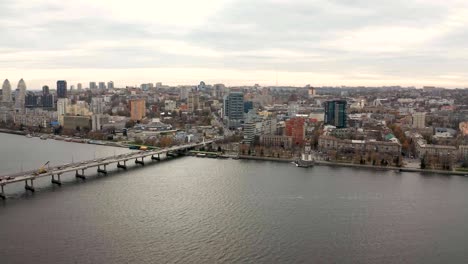 Aerial-view-footage-of-Dnieper-river.-Flying-over-cityscape-with-buildings.