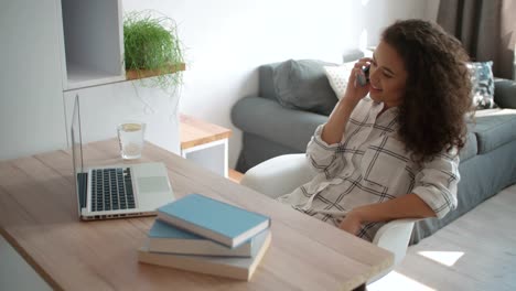 Young-woman-using-mobile-phone-at-home.