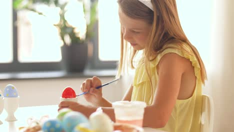 happy-girl-coloring-easter-eggs-at-home