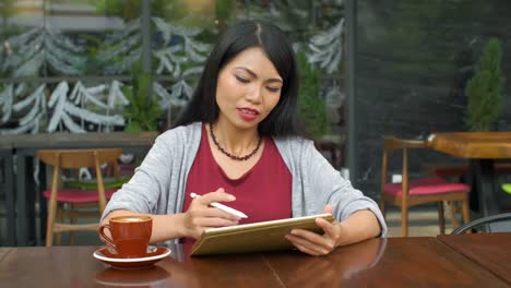 Asian-Woman-Working-in-Café