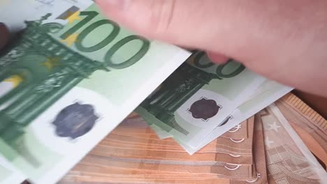 Man-Counting-100-Euro-Banknotes