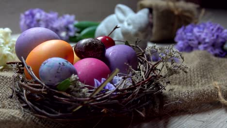 Child's-hand-takes-and-lays-festive-colored-egg