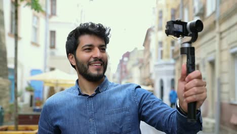 Man-With-Camera-Recording-Travel-Video-Blog-Outdoors