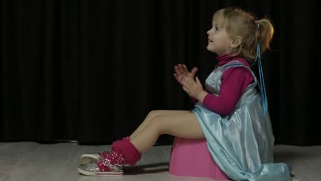 Little-girl-sitting-on-the-potty-and-watching-TV