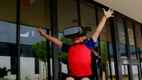 Front-view-of-disabled-African-American-schoolboy-using-virtual-reality-headset-in-school-corridor-4