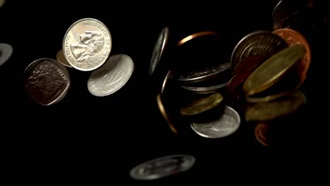 Coins-fall-on-a-black-background.-Slow-motion.