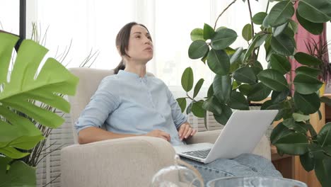 Woman-doing-video-chat-using-laptop-home