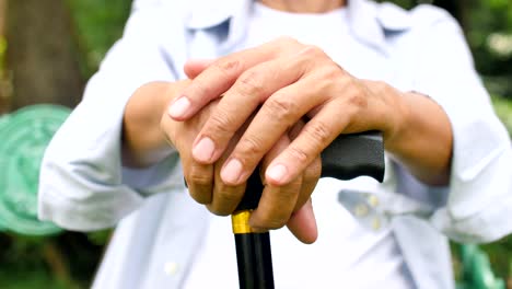 Close-up-of-senior-man-hands-holding-a-cane