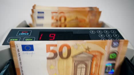 Modern-counting-device-calculates-euros-bills.