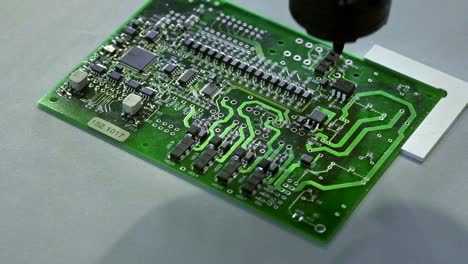 Mechanical-creation-process-of-electronic-circuits.-Creating-an-electronic-board.-Metal-needle-sets-the-chips-on-a-plastic-backing.-Solders-electronic-components.