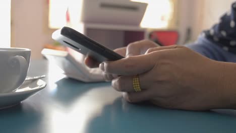 Woman-using-smart-phone-on-the-desk-at-home,-Typing-text-message.