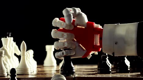 Robotic-hand-prosthesis-is-playing-chess-with-human-hand-on-black-background