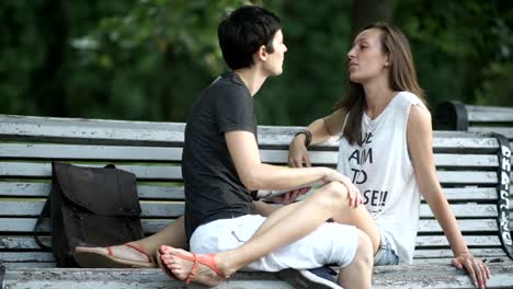 Beautiful-happy-lesbians-relaxing-on-bench-in-park