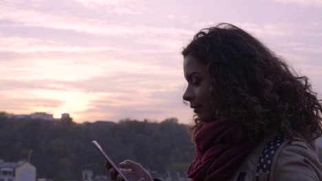 Young-lady-reading-message-on-smartphone-with-smile-on-face,-social-networks