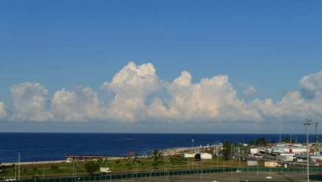 High-resolution-4k-time-lapse-video-of-cloudscape-movement-over-Black-Sea-surface-in-Sochi-after-sunrise-on-the-background-of-deep-blue-sky-and-wavy-water