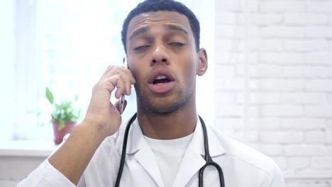 African-American-Doctor-Talking-on-Smartphone-in-Hospital