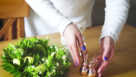 woman-arranges-beautiful-Easter-decorations-on-the-table