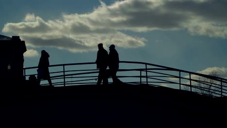 Silhouetten-von-Menschen-Fuß-die-Treppe-der-Steinbrücke,