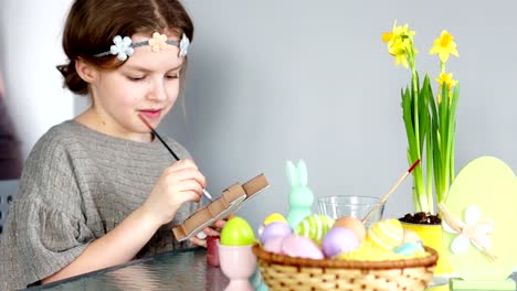 Happy-easter.-Father-and-daughter-paint-the-figure-of-the-Easter-bunny.-Family-traditions