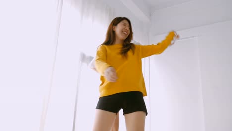 Young-asian-female-lesbian-couple-dancing-at-bedroom.-Lifestyle-friendship-concept.