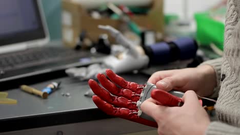 Professionals-work-with-hand-bionic-prosthesis,-at-laboratory-table-indoors