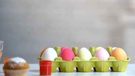 Chica-sorpresa-que-aparece-por-debajo-de-la-mesa-y-mirando-a-coloridos-huevos-de-Pascua