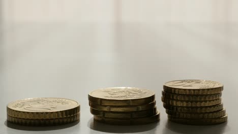 Euro-metal-coins-arranged-on-white-surface-slow-tilting-over-4K-2160p-UltraHD-footage---Slow-tilt-on-euro-money-change-on-white-background-3840X2160-30fps-UHD-video