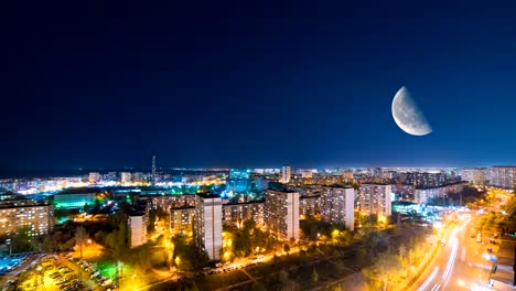 The-night-city-against-the-moon-background.-time-lapse