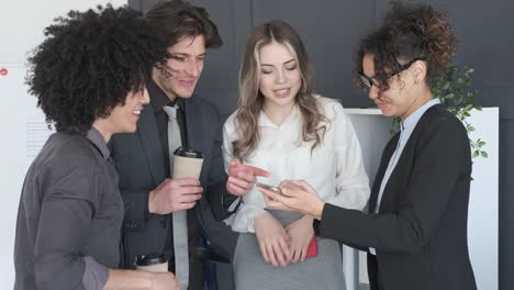 Business-colleagues-enjoying-media-content-on-mobile-phone